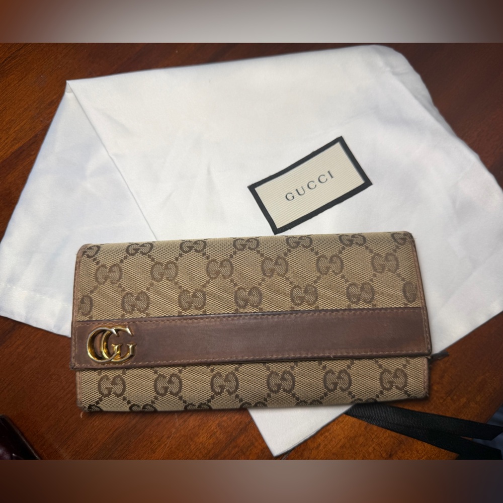 Gucci Brown Mono Long Wallet with dust bag and certificate of authenticity.